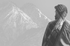 black and white composite mountains, man, buildings
