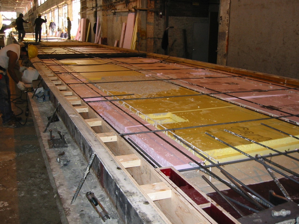 Figure 2: Composite panel in form with insulation partially placed. Note the longitudinal wire trusses that connect the wythes together and provide composite action (Losch 2005)